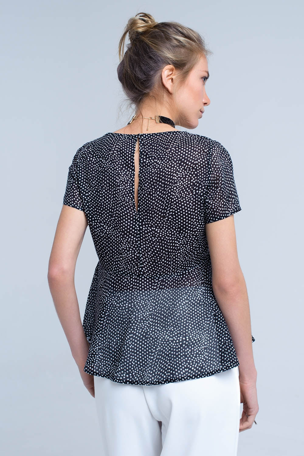 Black polka dot top with ruffle hem - Tops