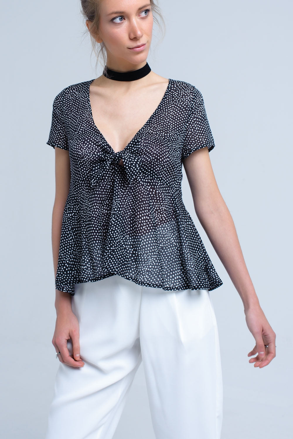 Black polka dot top with ruffle hem - Tops
