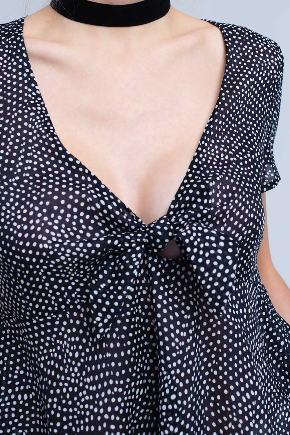 Black polka dot top with ruffle hem - Tops