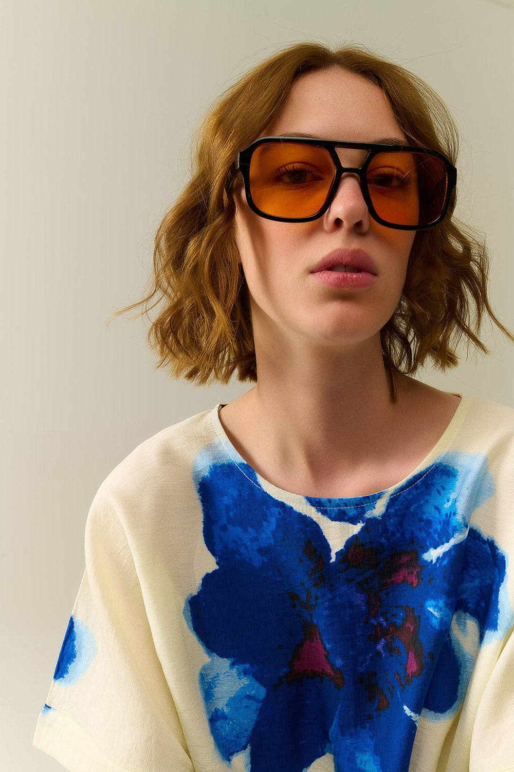 Sunglasses with black frames and orange lenses