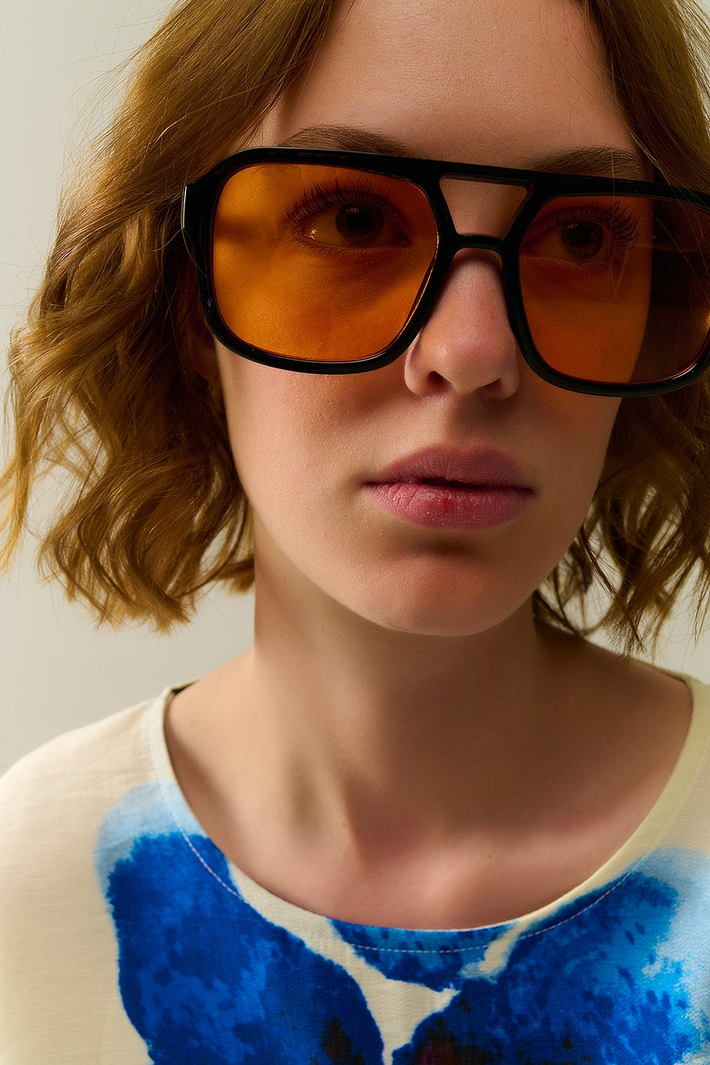 Sunglasses with black frames and orange lenses