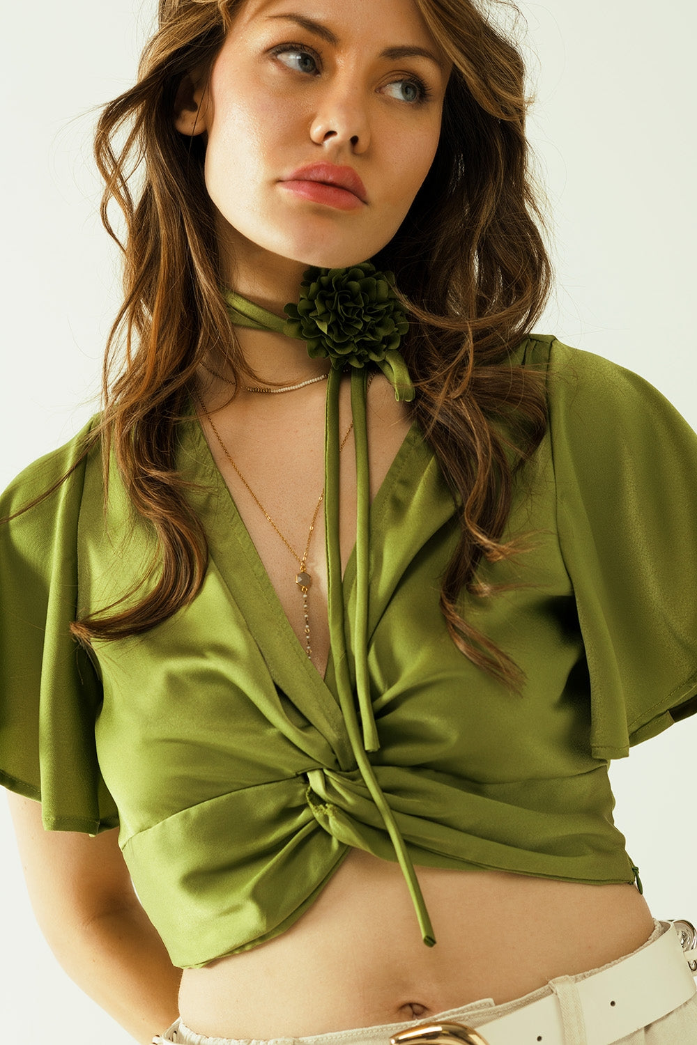 Green V-neck crop top with short sleeves and a flower detail on the neck - Tops
