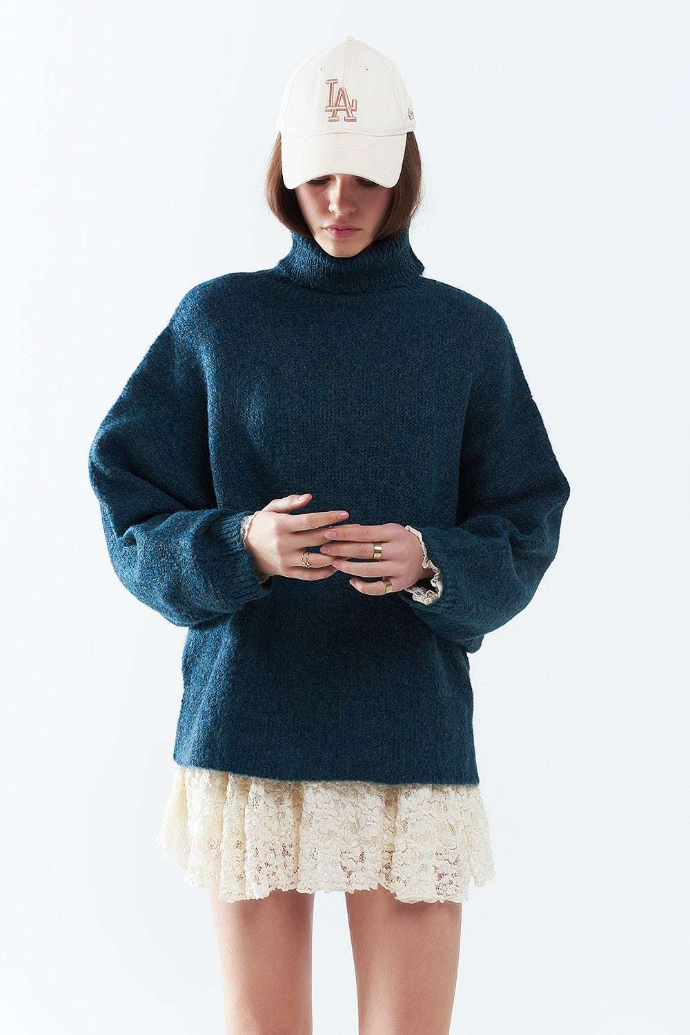 Oversized sweater in teal with a high neck and loose sleeves