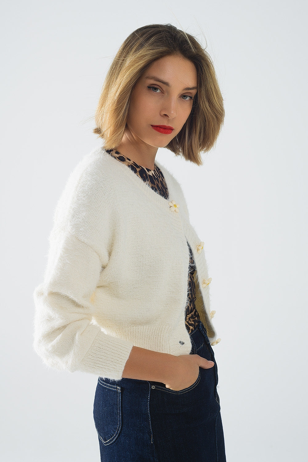 Short and fluffy cream cardigan with flower buttons Q2 Sweaters BoutiqueLua